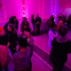 A group of people in fuchsia gallery space.