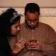 A couple checks a phone.